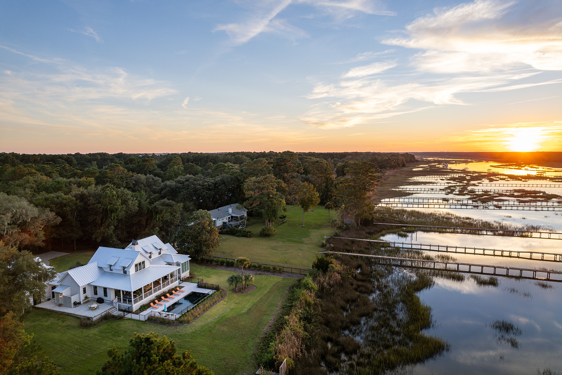Custom home along the river at sunset