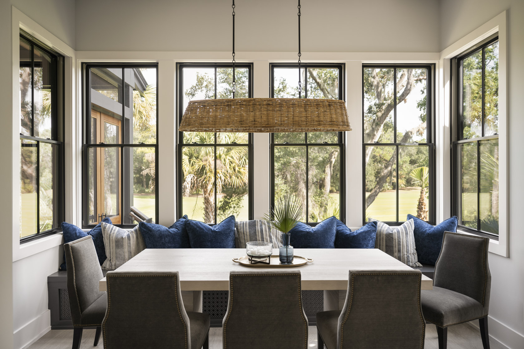 Large floor to ceiling glass windows in dining room, looking out over Kiawah Island