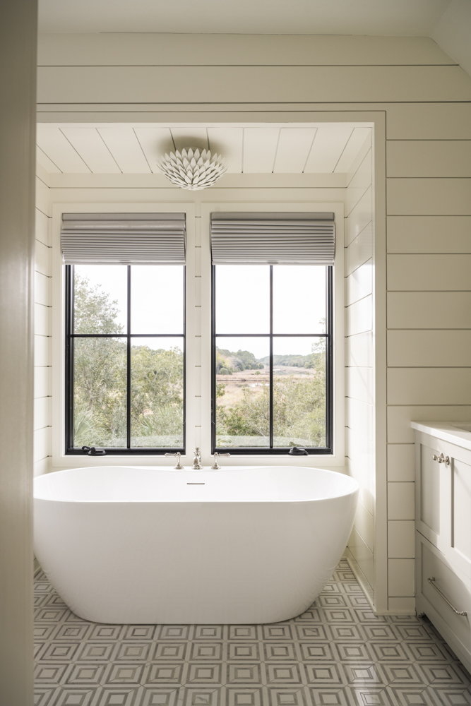 Bathroom Soaking Tub Soaking tub in bathroom with shiplap walls and geometric tile floors