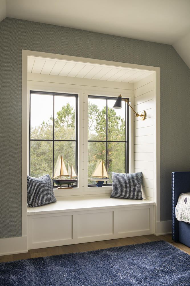 Whitlock - _4424 Reading nook with shiplap insets, patterned walllpaper, and blue area rug.