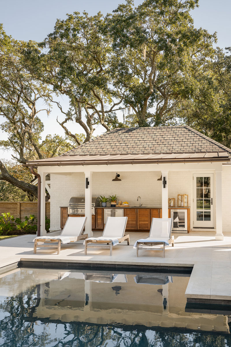 Outdoor Grilling Station White painted brick rear patio and outdoor grilling station in front of swimming pool