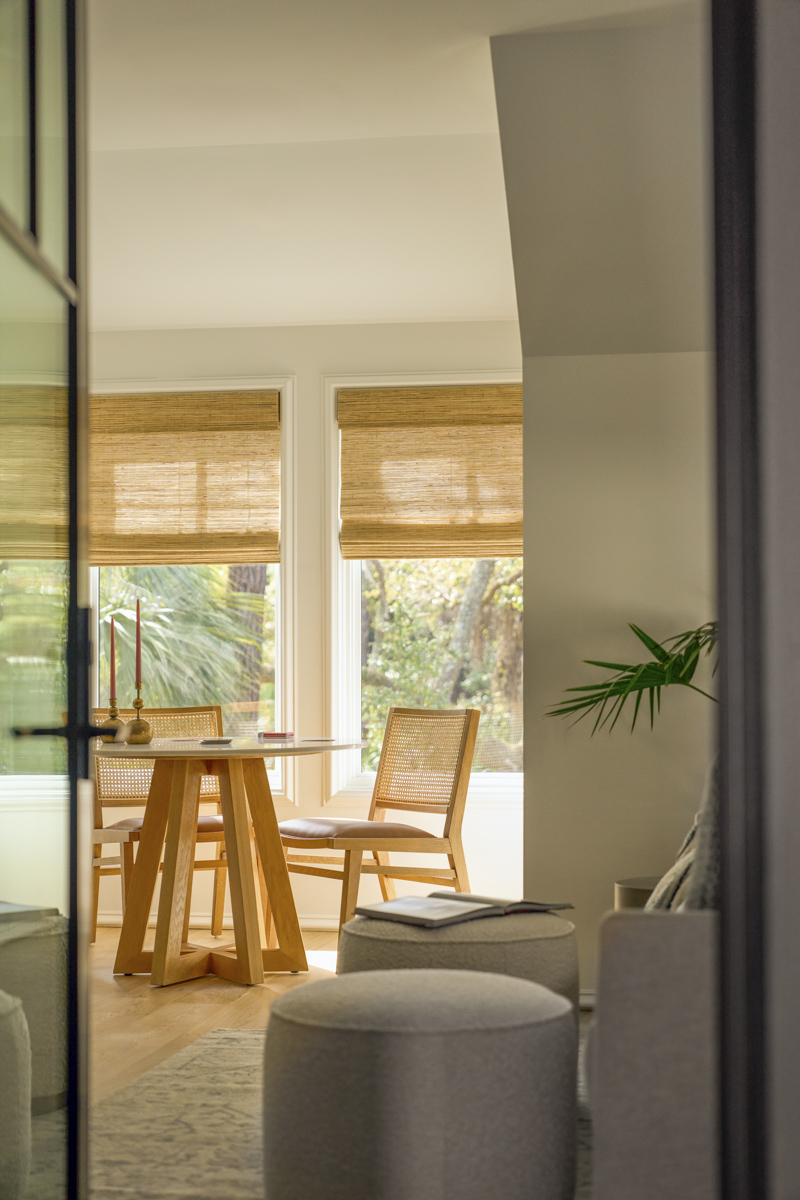 Sage-Vertical-doorway+table Brown leather sofa in full-height window nook with dark moody lighting