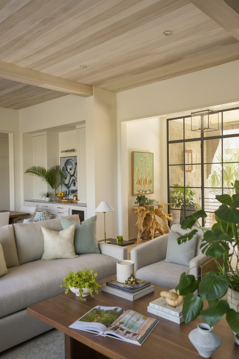 Sage-Vertical-livingroom Front door entry with exposed ceiling beams and summer wreath on the front door