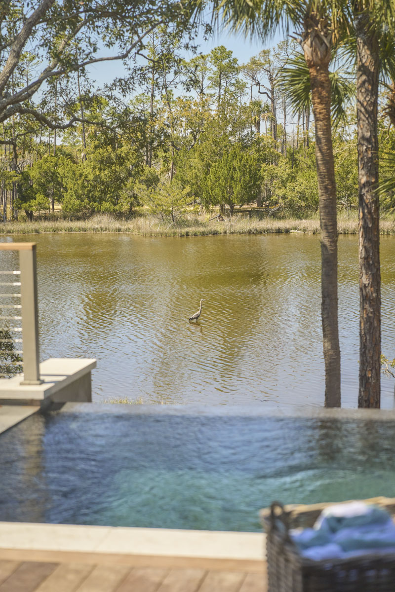 Sage-Vertical-water+heron Home office with build-in shelves and wicker accents